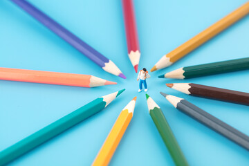 Miniature creative education concept pencils around schoolchildren