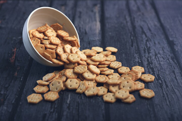Crispy baked salted biscuits in white bowl	
