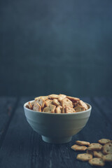 Crispy baked salted biscuits  in white bowl