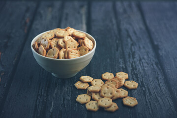 Crispy baked salted biscuits  in white bowl