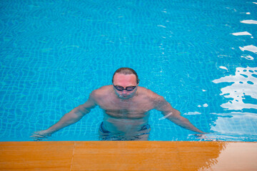 one athlete in glasses dives in the pool