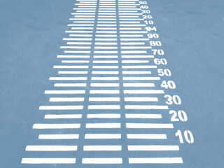 colorful basketball lines on an outdoor court,Long jump distance calculation with printed numbers