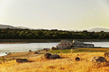 Beautiful view of Valmayor reservoir with dense vegetation in the background in Madrid, Spain