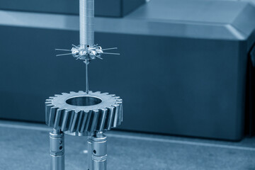 Closeup scene the touch trigger probe of CMM machine  measuring the bevel gear part .