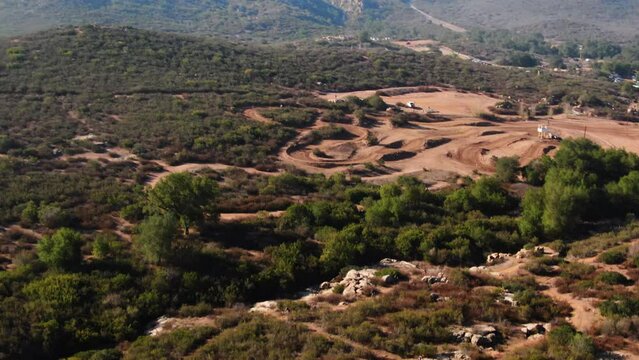 4K Drone Bikers Competing On Trail With Mountain Reveal