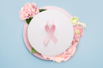 Composition with pink ribbon and flowers on light background. Breast cancer awareness