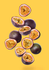 Delicious flying passion fruit on yellow background