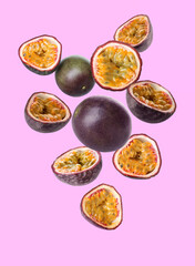 Delicious flying passion fruit on lilac background