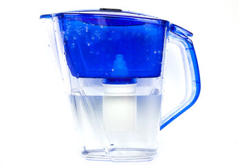 A jug-type household water filter with a replaceable filter nozzle with filtered water inside on a...