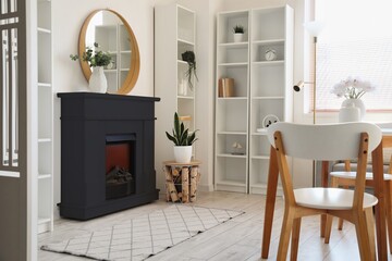Black fireplace and shelf units near white wall in stylish living room