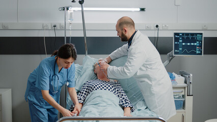 Medical team rushing to help patient with respiratory problem in hospital ward bed. Doctor using oxygen tube mask to cure hyperventilating and disease of retired patient with sickness.