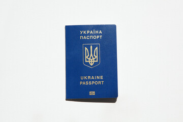 Ukrainian passport with golden trident symbol. Biometrical Ukraine passport id. Passport of citizen of Ukraine on white background, close-up, copy space. Inscription in Ukrainian and English