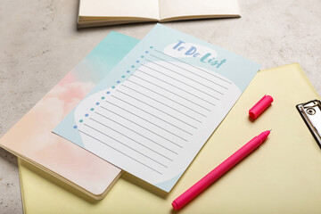 Blank to do list, clipboard and pen on grunge background