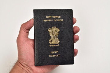 Indian Passport in Hand Isolated on White Background
