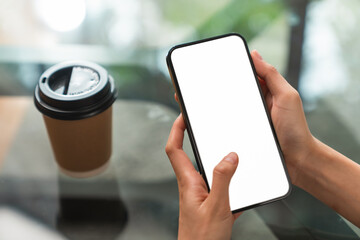 Hand holding smartphone mockup of blank screen. Take your screen to put on advertising.