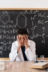 Chronic Fatigue Syndrome. A man works as a school teacher in a classroom. A handsome young Arab...