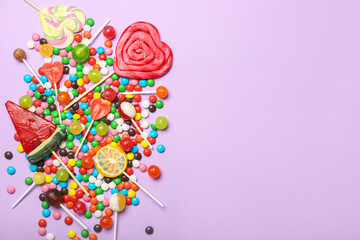 Many sweet candies on lilac background