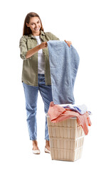 Beautiful housewife with laundry and big basket on white background
