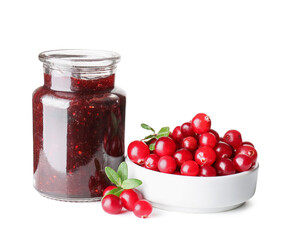 Jar with tasty lingonberry jam and fresh berries on white background