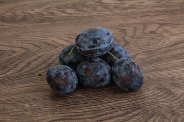 Ripe plum heap over background