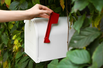Female hand with vintage mailbox outdoors, closeup