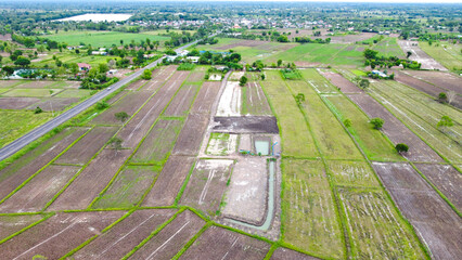 Aerial drone view of green fields and farmland.