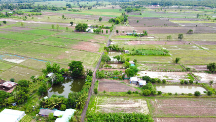 Aerial drone view of green fields and farmland.