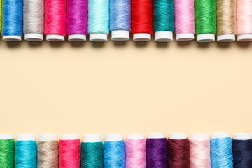 Sewing threads on beige background
