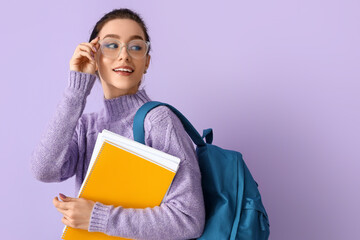 Portrait of beautiful female student on color background