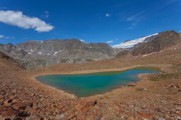 Small turquoise glacial lake among ancient moraines. Gepatschferner is visible. Vallelunga, Alto Adige Sudtirol, Italy