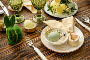 Stylish table setting for Easter celebration on wooden background