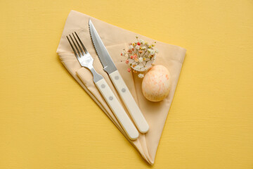 Stylish table setting for Easter celebration with gypsophila flowers on yellow background