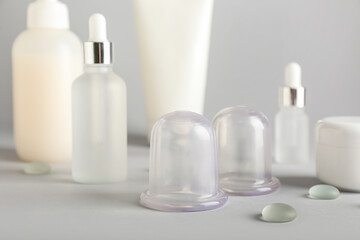 Fototapeta na wymiar Vacuum jars for anti-cellulite massage on light background
