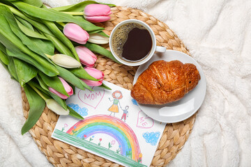Picture with tulips, cup of coffee and croissant on white blanket. Mother's Day celebration