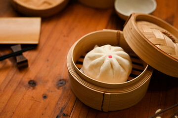 Delicious homemade Chinese steamed pork bun in a bamboo steamer