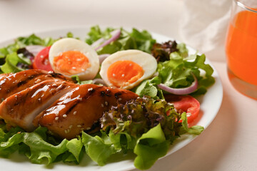 Grilled teriyaki chicken breast with boiled eggs and fresh organic salad mix.