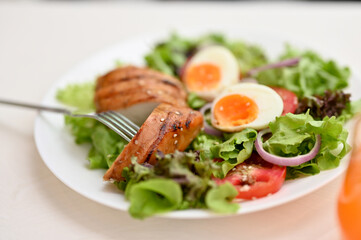 A plate of fresh healthy organic salad mix with roasted bbq chicken breast