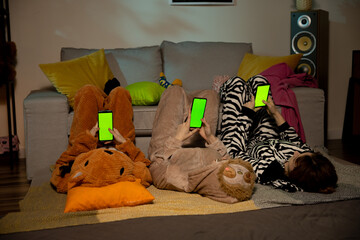 Group of teenage girls using a cellphone on the bedroom at home