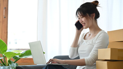 Female business startup entrepreneur talking on the phone with her supplier