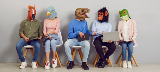 Funny people with animal faces talking while sitting in row in waiting room. Company employees or...