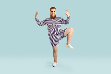 Funny fat guy enjoying his happy summer holiday. Full body length portrait of cheerful goofy chubby...
