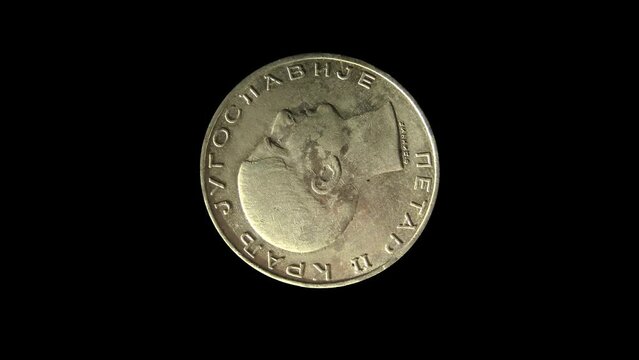 Rotating obverse of Yugoslavia coin 50 dinara 1938 with inscription meaning PETAR II THE KING OF YUGOSLAVIA. Isolated in black background. 