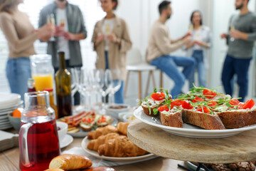 Brunch table setting with different delicious food.and blurred view of people on background