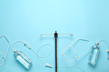 IV infusion set on light blue background, flat lay. Space for text