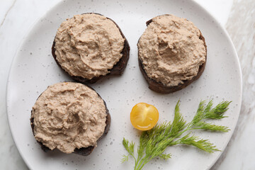Slices of bread with delicious pate, tomato and dill on table, top view