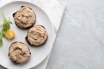 Slices of bread with delicious pate, tomato and dill on light grey marble table, top view. Space for text