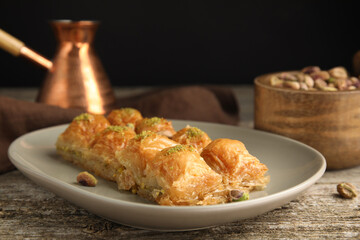 Delicious baklava with pistachios on wooden table