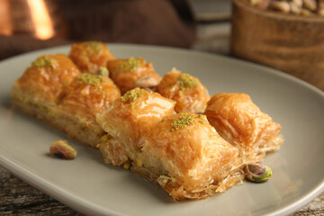 Delicious baklava with pistachio nuts on table, closeup
