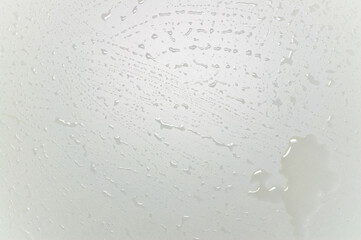 white table surface with drops on it