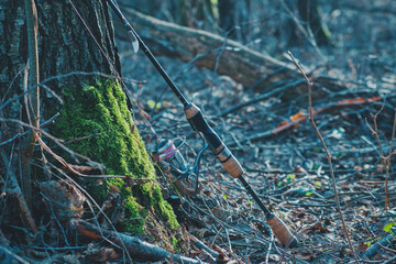 Spinning trout fishing. Fishing tackle on the river bank.